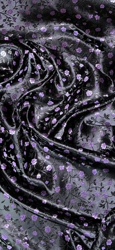 a black and purple fabric with flowers on it