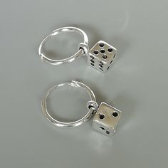 A PAIR of sterling silver hoops. Comes with a detachable dice charm. The charm is multipurpose and can be used with a neck or bracelet chain too. Dimension: Hoop- 12x1 mm Charm: 5 x8 mm Drop length- 19 mm These earrings are made of real 925 hypoallergenic sterling silver. Please let me know if you want the piece in a gift box. I can write out a message from you to the receiver if needed. Please be free to contact me at... bhavnakwintra1956@gmail.com More hoops: https://www.etsy.com/your/shops/Th Hoop Earring With Charm, Nickel-free Silver Dangle Huggie Earrings, Silver Nickel-free Dangle Huggie Earrings, Silver Dangle Huggie Earrings Nickel-free, Adjustable Sterling Silver Huggie Earrings, Silver Huggie Earrings With Charms, Nickel-free Sterling Silver Huggie Earrings As Gift, Silver Charm Hoop Earrings, Silver Dangle Hoop Earrings With Charms