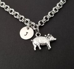 Personalized Antique Silver Pig Bracelet!  A sweet pig charm on a lovely chain bracelet makes the perfect gift for you or your best friend.The pig bracelet charm is made from zinc alloy and measures 15 mm by 21 mm.  The bracelet is high quality zinc alloy and measures 8.5".  The pig bracelet can be personalized with a .5" silver plated disc stamped with the initial of your choice.  The charm and initial disc are connected to the bracelet with sturdy split rings that will never fall off!  You can Personalized Novelty Charm Bracelet, Novelty Metal Charm Bracelet As Gift, Novelty Metal Charm Bracelet Gift, Pig Bracelet, Pig Jewelry, Animal Bracelet, Bracelet Initial, Personalized Bracelet, Split Rings