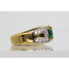 This is part of Chairish’s Fine Jewelry assortment.  This gorgeous David Webb Emerald and Diamond ring comes out of Paris and it is stunning. The ring features a gorgeous true Emerald Green Emerald square cut stone of approximately 1.25 to 1.50 carats and 18 Diamonds totaling approximately 0.90 carats. Metal: 18K Yellow Gold Weight: 13.8 Grams Stone: Square cut Emerald 1.25-1.50 Carats Stones:18 Diamonds .90 carats Size: 5-6 w/inner guard Dimensions: size 5-6.  This ring is double stamped Webb, Luxury Emerald Cut Gemstones For Anniversary, Timeless Cubic Zirconia Emerald Ring For Anniversary, Square Cut Sapphire Ring With Diamonds For Formal Occasions, Luxury Emerald Ring With Baguette Cut And Accent Stones, Emerald Baguette Cut Ring With Accent Stones, Classic Emerald Diamond Ring With Accent Stones, Luxury Emerald Cut Diamond Signet Ring, Classic Brilliant-cut Emerald Gemstones, Classic Brilliant Cut Emerald Gemstones