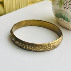 Cool 60s brass boho bangle etched with stripes and flowers. Great patina! Great for your growing stack of bangles. Will fit right in! Antique Gold Vintage Bangle As Gift, Retro Gold Bangle As A Gift, Retro Gold Bangle As Gift, Vintage Bronze Bracelets For Festival, Vintage Handmade Bangle For Wedding, Vintage Bangle With Antique Finish As Gift, Bohemian Brass Bangle For Wedding, Bohemian Bronze Bangle For Ceremonial Use, Vintage Etched Bangle As Gift