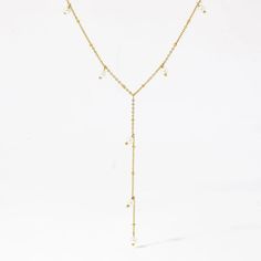 This 18k gold lariat necklace features delicate pearls intricately woven throughout, creating a luxurious and elegant design Luxury Gold Lariat Necklace, Fine Jewelry Lariat Necklace For Wedding, Elegant Necklace With Delicate Chain And Long Drop, Pearl Pendant Lariat Necklace, Long Drop Pearl Chain Lariat Necklace As Gift, Long Drop Pearl Chain Lariat Necklace For Gifts, Luxury Gold Lariat Necklace With Delicate Chain, Long Drop Lariat Necklace With Pearl Chain As Gift, Dainty Pearl Chain Lariat Necklace