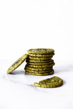 a stack of cookies sitting next to each other on a white counter top with one cookie in the middle