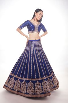 Blue silk lehenga with intricate motifs at the base and delicate lines of zardozi paired with matching blouse and net dupatta with thick main border and thinner borders on 3 sidesFrom Chamee and Palak 's The Wedding Edit collectionDELIVERY TIMEPlease allow 8-12 weeks for your outfit to arrive.FABRIC DETAILSSilk And NetProfessional cleaning only. Blue Chanderi Sets For Reception, Royal Blue Anarkali Set With Cutdana, Blue Raw Silk Sets With Cutdana, Blue Raw Silk Sets With Cutdana Details, Blue Raw Silk Anarkali Set With Dori Work, Blue Anarkali Chanderi Lehenga, Blue Anarkali Style Chanderi Lehenga, Royal Blue Sharara For Reception With Traditional Drape, Royal Blue Traditional Drape Sets With Cutdana