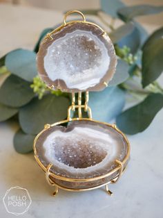 two pieces of jewelry sitting on top of a table