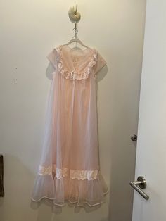 "Estate sale find. Beautiful Vintage MCM 1960's-1970's  Shadowline Peignoir Set | |Nightgown & Robe Ensemble Peachy Pink. In nylon/chiffon.  Perfect honeymoon nightgown and collectors item. Tag size is Medium.  Please review pixs, video, and measurements below.  All sales final. 20\" PTP 53\" STH *This is a vintage item which has history and was pre-loved. All major flaws are listed. **I do not accept returns unless the item was misrepresented. Please message me first and ask questions! I want t Spring Evening Nightgown With Lace Trim, Spring Sheer Evening Sleepwear, Sheer Evening Sleepwear For Spring, Spring Evening Sheer Sleepwear, Vintage Sheer Sleepwear For Evening, Feminine Sheer Gown, Spring Evening Lace Sleepwear, Vintage Sheer Lace Nightgown, Vintage Sheer Nightgown For Wedding Night