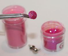 a toothbrush sticking out of a jar filled with pink jello next to two small jars