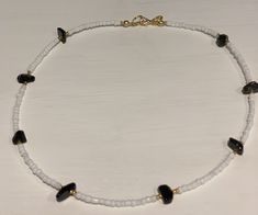 Beautiful beaded necklace containing pretty black onyx gemstone chips and white and gold glass seed beads Gold plated fastenings Other gemstones available, please check out my other listings or drop me a message and I can make up in your desired stone As this contains natural gemstones - they may vary slightly in colour, shape, design and size As this item contains small parts please keep away from small children as it may be a choking hazard To prevent damage please remove before swimming, show Heart-shaped Colorful Beads Necklace For Jewelry Making, Gold Heart Necklace With Colorful Beads, Elegant Heart-shaped Jewelry With Colorful Beads, Elegant Heart-shaped Colorful Beads Jewelry, Elegant Heart-shaped Colorful Beaded Jewelry, Heart Pendant Jewelry With Colorful Beads For Gift, Gold Necklaces With Round Heart Beads, Gold Necklaces With Heart-shaped Round Beads, Heart-shaped Colorful Beads Jewelry For Gifts