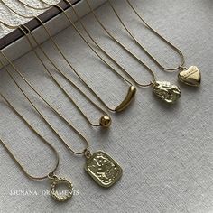 Plated Heart Pendant Necklaces, Gold Dangle Necklaces In Alloy, Gold Alloy Dangle Necklaces, Trendy Gold Heart Charm Necklaces, Trendy Gold Dangle Necklaces, Heart Charm Alloy Necklace With Heart Pendant, Plated Metal Charm Necklace As Gift, Plated Dangle Necklaces For Gifts, Trendy Gold Heart Pendant Necklace