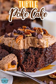 a slice of turtle poke cake on a plate with the rest of the cake in the background