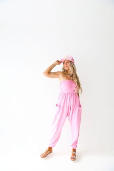 You will want to LIVE in these strapless jumpsuits! They feature an elastic-banded bust area with ruching up the middle The relaxed oversized fit is so trendy right now and makes this outfit easy to pair with sneakers or sandals, or even throw on a trucker! They have elastic banding around then ankles so that they are short-girl approved too! Model is 5'4 wearing a size small Pink Jumpsuit, Strapless Jumpsuit, Solid Dress, Short Girls, Set Dress, The Middle, Sweater Top, Print Dress, Jumpsuit Romper