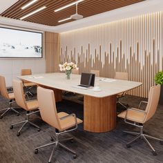 a conference room with chairs and a large table in front of a projector screen