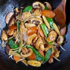 stir fry with chicken and vegetables in a wok