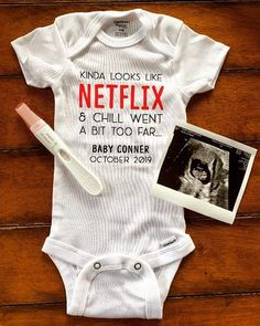 a baby's bodysuit with an image of a dog on it and the words, kinda looks like netflix & chill went a bit too far