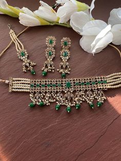 Elegant Indian Necklace Gold Plating. Indian Bridal traditional One Gram Jewelry Choker Set. Gorgeous 24 K gold plated. Beautiful and elegant Kundan and Meenakari Green beads choker. Perfect for Indian weddings. Size- Adjustable Premium Quality and High craftsmanship Gorgeous 24 K gold plated. All the raw material used in this product is of high quality and is handcrafted with love. Premium Quality and High craftsmanship 100% Satisfaction Guarantee: Long Lasting Plating, High-Quality Stones. Gif Kundan Chandbali Choker With Intricate Design, Kundan Choker For Wedding And Eid, Bollywood Chandbali Choker With Zari Work, Festive Stone Work Choker For Reception, Diwali Chandbali Stone Work Choker, Bollywood Chandbali Heavy Choker, Temple Jewelry Kundan Choker For Reception, Stone Work Choker For Reception And Diwali, Bollywood Style Wedding Choker With Zari Work