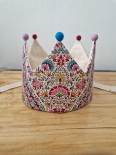 a colorful crown sitting on top of a wooden table