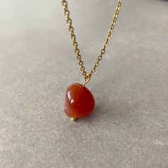 "NATURAL CARNELIAN CHAIN NECKLACE This necklace features a dainty, natural gemstone threaded on a 14k Gold Filled, Stainless Steel chain. Available in color options, this necklace is ideal for layering & makes the perfect gift! Please visit our store for other color options! Carnelian gives courage and promotes positive life choices. Carnelian is a crystal of action, overcoming procrastination or indecision. ☆ Each of the stones we use to create necklaces were formed by nature over years. Each one is unique and beautiful just like nature itself.  We do not process or change our stones in any way, we accept their \"unique and raw\" beauties. We don't polish away \"flaws\" in the stones but rather leave them in their natural state.  Just like people, each stone has special characteristics un Yellow Gold Chalcedony Jewelry Gift, Adjustable Gold Carnelian Necklace, Orange Gemstone Necklaces As A Gift, Orange Agate Gemstone Necklace, Orange Agate Necklace For Gift, Dainty Gemstone Chain Necklace Gift, Gold Chalcedony Jewelry As A Gift, Agate Pendant Necklaces With Adjustable Chain, Agate Pendant Necklace With Adjustable Chain