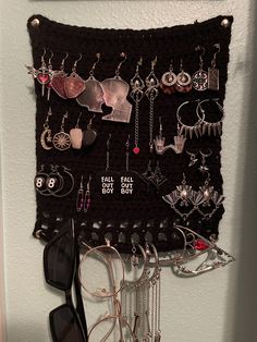 a wall mounted jewelry rack with sunglasses and eyeglasses