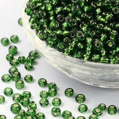 green glass beads in a bowl on a table