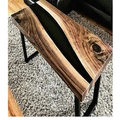 a wooden table sitting on top of a carpeted floor next to a black chair