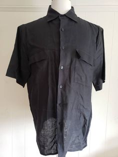 This is a vintage, Bruno, black, short sleeved, washable linen shirt with a collar and buttons down the front. The measurements are: Armpits: 24.5 inches across Length from back of the neck: just shy of 30 inches Don't forget to stop in at my other Etsy shop... http://www.etsy.com/shop/xtdesigns If you have a wish list or are looking for something specific, please ask. I may have exactly what you are looking for. As always please convo me with any questions or concerns regarding this item or wit Black Shirt With Lapel Collar For Summer, Vintage Solid Color Short Sleeve Shirt, Fitted Short Sleeve Black Shirt With Buttons, Classic Black Short Sleeve Shirt, Vintage Black Shirt For Work, Black Shirt With Lapel Collar And Placket, Classic Fitted Black Short Sleeve Shirt, Black Cotton Short Sleeve Shirt With Spread Collar, Black Short Sleeve Shirt With Buttons