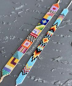 two bracelets made out of colorful beads on a gray surface with drops of water