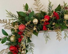 a christmas garland with ornaments and greenery