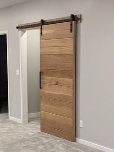 an empty room with a sliding door in the middle and carpeted flooring on the other side