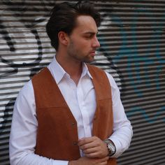 This rust-colored vintage brushed leather vest has a collarless V neckline and closes in the front with four snap buttons. The vest has two pockets on the front and features a full satin back with a slip-buckle half-belt. Condition: Excellent (Professionally Cleaned ... soft and supple, with no stains, tears, wear spots, or weaknesses in the seams. Note that there are a couple of scratches on the satin on the back, but this is no way diminishes from the Excellent quality of this vintage piece.) Vintage Business Vest For Fall, Classic Brown Vest For Spring, Beige Business Vest For Fall, Brown Business Vest For Fall, Brown Leather Vest For Spring, Brown Leather Vest For Workwear, Brown Leather Spring Vest, Fitted Vintage V-neck Vest, Fitted V-neck Vintage Vest