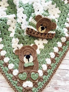 there is a crocheted blanket with two teddy bears on it