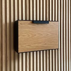 a close up of a wooden object on a wall with vertical lines in the background