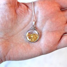 "Vibrant handcrafted brand new sterling silver genuine yellow sapphire shaker locket! This radiant pendant is dime sized with coin style bezels, and clear lucite covers. The round charm showcases genuine fancy sapphires in bright yellow hues. There is an estimated 2.5 CTW of faceted baguette cut sapphires sparkling within the double sided locket's clear lucite covers. A gorgeous piece of brand new gemstone jewelry, featuring beautiful genuine gems! ERA - New METAL / MATERIAL - Sterling silver lo Fine Jewelry: Silver Yellow Sapphire, Fine Jewelry Silver Yellow Sapphire Jewelry, Silver Yellow Sapphire Jewelry For Anniversary, Round Faceted Topaz Jewelry, Silver Jewelry With Yellow Sapphire For Anniversary, Citrine Birthstone Round Pendant Jewelry, Citrine Gemstone Jewelry Round Pendant, Faceted Round Topaz Jewelry, Citrine Round Pendant Necklace For Anniversary