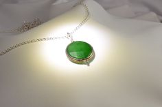 "This handcrafted Nepalese, two-sided, 22mm faceted, genuine green jade pendant hangs on a 26-inch rhodium cable chain with a lobster clasp. This unique piece makes a memorable green gemstone jewelry gift for her. NOTE: This listing is for one necklace with one pendant, but you can choose to purchase just the pendant without the chain (see the drop down menu). The \"Pendant - No Chain\" option includes the pendant with a bail/top loop and no chain. NOTE: Our Nepal pendants are exquisite, but unl Green Crystal Necklaces With Gemstone Beads As Gifts, Bohemian Green Onyx Beaded Necklaces As Gift, Green Crystal Necklace With Gemstone Beads As A Gift, Handmade Necklaces With Round Beads For May Birthstone, Handmade Necklaces With May Birthstone Round Beads, Handmade May Birthstone Necklaces With Round Beads, Green Jade Beaded Necklaces As Gift, Jade Beaded Pendant Necklaces For Gifts, Green Gemstone Beaded Necklaces As Gift