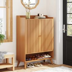 a wooden cabinet with shoes on it next to a mirror