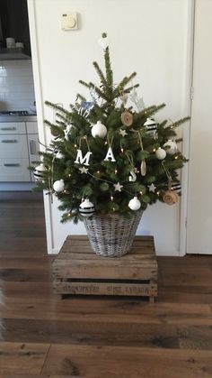 a small christmas tree sitting on top of a wooden crate