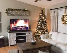 a living room with a christmas tree and fireplace