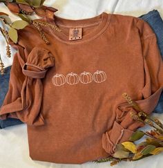 Fall Pumpkin Burnt Orange Comfort Colors Long Sleeve Shirt Welcome autumn with cozy style in our Fall Pumpkin Burnt Orange Comfort Colors Long Sleeve Shirt. Designed for both comfort and seasonal flair, this shirt is perfect for crisp fall days, pumpkin patch adventures, and festive gatherings. Key Features: Festive Design: Features a delightful pumpkin graphic with intricate autumn details, capturing the essence of fall. The design adds a touch of whimsy and seasonal charm, making it a must-hav Casual Brown T-shirt For Fall, Trendy Cozy Fit Tops For Fall, Trendy Soft-washed Fall Tops, Soft-washed Cozy Fit Top For Fall, Trendy Soft-washed Tops For Fall, Cozy Fit Soft-washed Top For Fall, Fall Long Sleeve Relaxed Fit T-shirt, Soft-washed Casual T-shirt For Fall, Trendy Brown Long Sleeve T-shirt