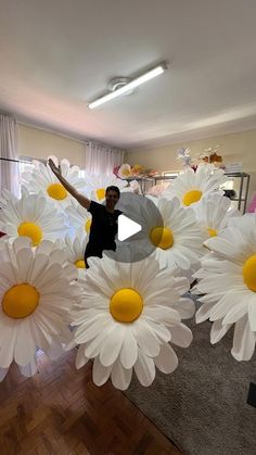 a man is surrounded by fake white flowers