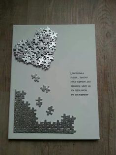 a card with puzzle pieces on it that says love is in the air, and an image of a heart