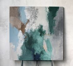 an abstract painting is hanging on the wall