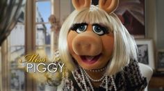 the miss piggy character is wearing pearls