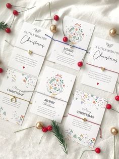 the wedding stationery is laid out on top of each other and decorated with christmas decorations