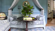 a living room with blue walls and furniture