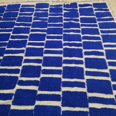 a blue and white rug on the floor