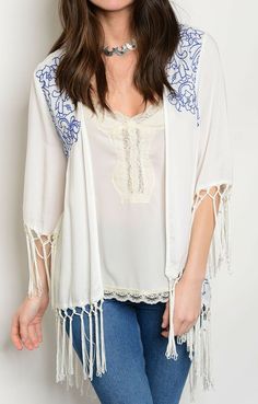 White Blue Embroidered Fringe Open Front Cardigan/Wrap/Cover-Up   ENTRO CLOTHING BRAND COVER-UP NEW WITH TAG. SIZE SELECTED IN THE PULL DOWN ABOVE. 100% RAYON 3/4 SLEEVES. LIGHTWEIGHT FABRIC. TRIMMED WITH 6 1/2" FRINGE. ASYMMETRICAL CUT, VEE SHAPE BACK. GENEROUSLY SIZED.     APPROXIMATE SHOULDER TO HEM LENGTH AT FRONT (EXCLUDING FRINGE): S-22.5", M-23", L-24". BACK CENTER LENGTH (EXCLUDING FRINGE): S-33", M-33", L-34". ARMPIT TO ARMPIT, FLAT: S-22", M-23", L-24". Item comes from a non smoking, p White Shawl For Beach In Spring, Embroidered Open Front Cardigan, Spring Blue Embroidered Cardigan, White Open Front Cardigan For Festival, White Open Front Festival Cardigan, Spring Open Front Cover-up With Tassels, Blue Bohemian Shawl For Spring, White Embroidered Open Front Kimono, Bohemian Blue Open Front Top