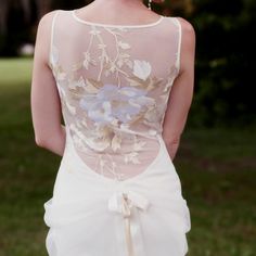 the back of a woman's dress with flowers on it