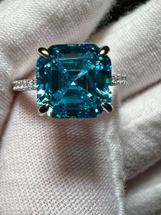 3CT Asscher Cut Cyan Created Blue Tourmaline 925 Sterling Silver Platinum Ring Size 7.  A gorgeous hidden halo add to this glorious ring.  Accents are grade 5A zirconia for sparkle! Stunning sparkle and color!   Blue tourmaline is the general term applied to two rare varieties of tourmaline: Paraiba tourmaline and indicolite tourmaline. Pure blue tourmaline is exceptionally rare, since most blue tourmaline exhibits a noticeable secondary green hue. Blue Emerald-cut Moissanite Jewelry, Blue Emerald Ring With Halo Setting, Blue Emerald Halo Setting Ring, Blue Emerald Rings With Halo Setting, Gia Certified Aquamarine Jewelry Ring, Gia Certified Aquamarine Ring, Blue Emerald Jewelry With Accent Stones, Gia Certified Blue Topaz Ring, Blue Moissanite Jewelry With Halo Setting