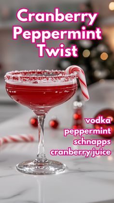 a red drink with a candy cane in it