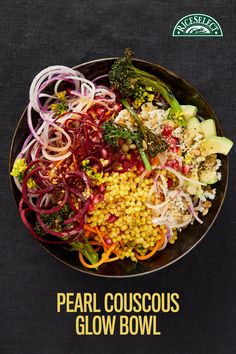 a bowl filled with lots of different types of food on top of a black table