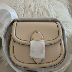 Brand New Coach Beat Saddle Leather Brass/Ivory Bag In Original Packaging Price Is Firm Glovetanned Leather Inside Zip And Slip Pockets Snap Closure, Fabric Lining Outside Open Pocket Detachable Strap With 24" Drop For Shoulder Or Crossbody Wear 8 3/4" (L) X 7" (H) X 2 1/4" (W) Style No. C0749 Luxury Cream Bags For Errands, Luxury Neutral Top Handle Shoulder Bag, Luxury Neutral Leather Shoulder Bag, Designer Beige Shoulder Bag With Removable Pouch, Luxury Neutral Satchel Shoulder Bag, Classic Neutral Shoulder Bag With Gold-tone Hardware, Luxury Bags With Detachable Strap In Neutral Color, Luxury Bag With Detachable Strap In Neutral Color, Luxury Beige Bags With Leather Lining